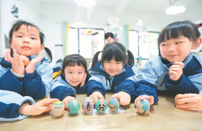 3月18日，貴州省黔南布依族苗族自治州都勻市青云湖幼兒園的小朋友們在體驗立蛋民俗。肖 偉攝（人民視覺）